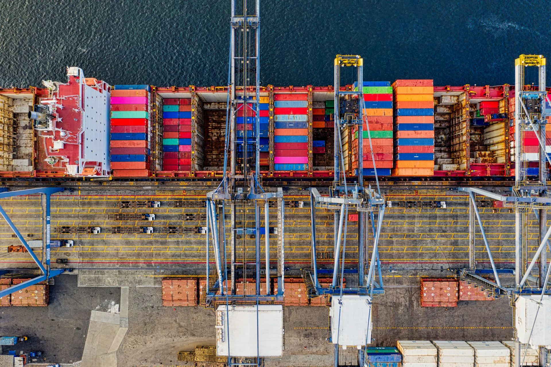 Illustrative stock photo: Aerial view of a container vessel and cranes at port